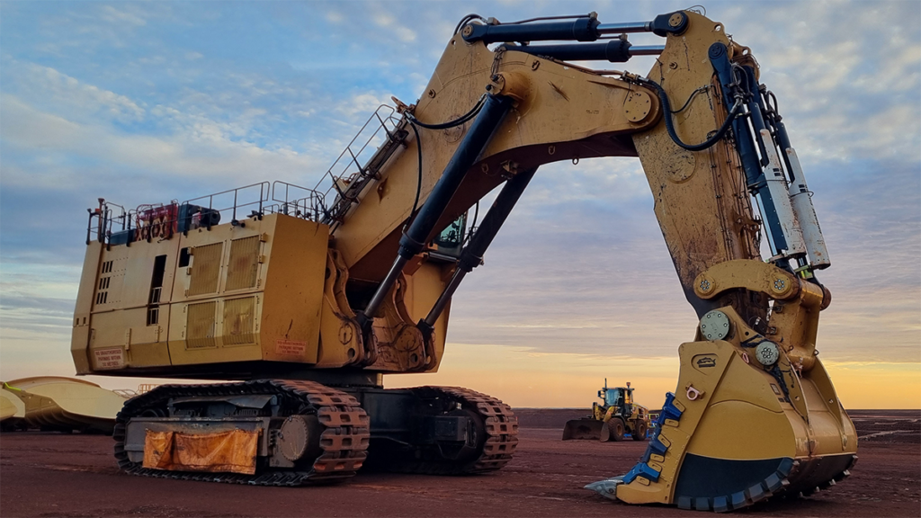 Barracuda T2 bucket attached to hydraulic excavator basking in the glow of the setting sun.