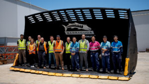 Schlam's engineering and manufacturing teams standing inside Glencore's big CAT 995 Barracuda bucket.