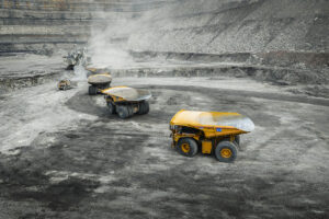 Haul trucks (CAT 797F) fitted with Hercules Ultra truck beds being loaded by excavator in an open pit mining operation
